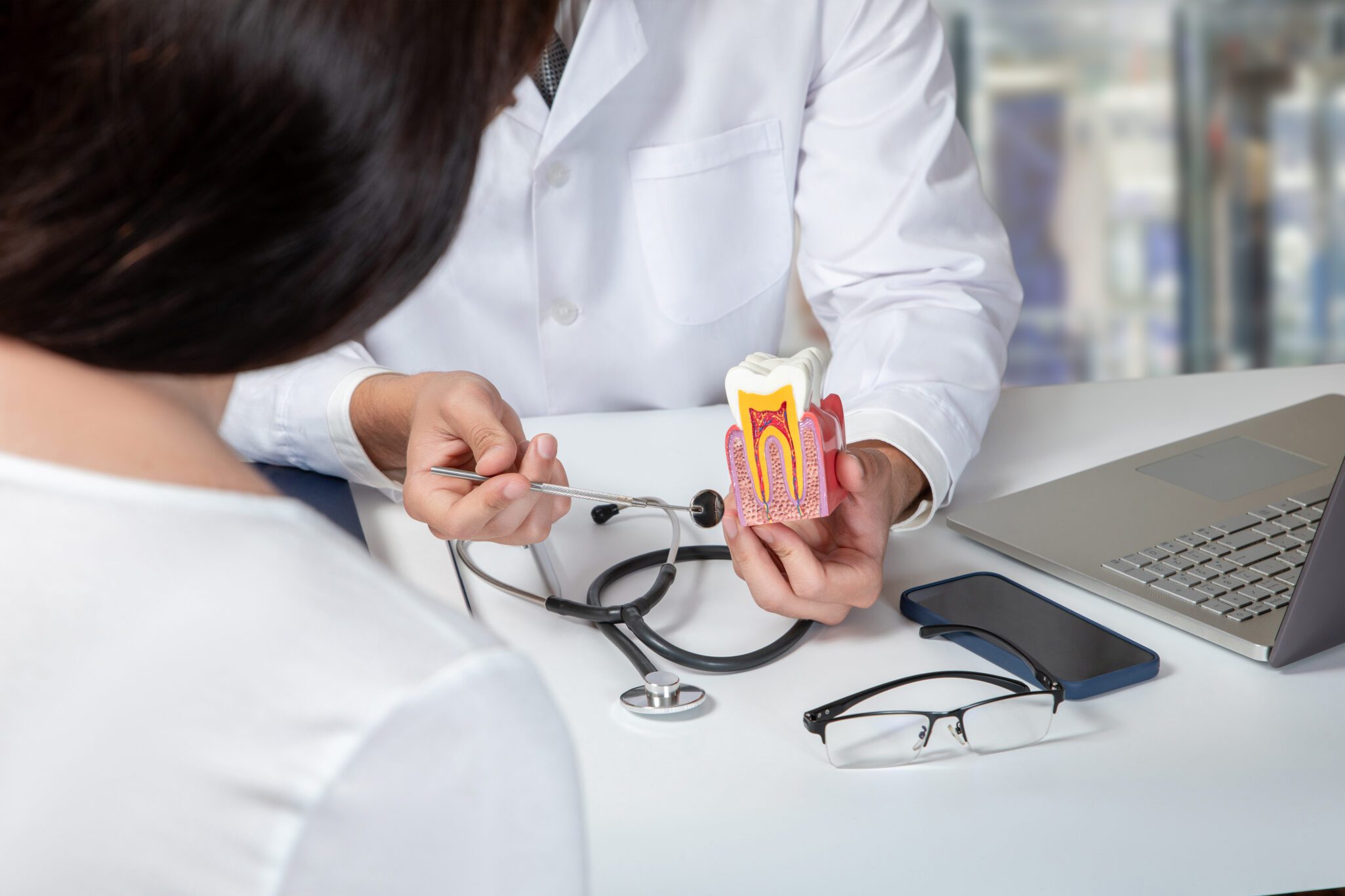 Doctor consulting a female patient about dental diseases 